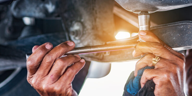 Hand,Mechanic,In,Repairing,Car,change,The,Oil