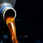 Pour,Engine,Oil,From,The,Lubricant,Bottle.,Engine,Background,,Oil